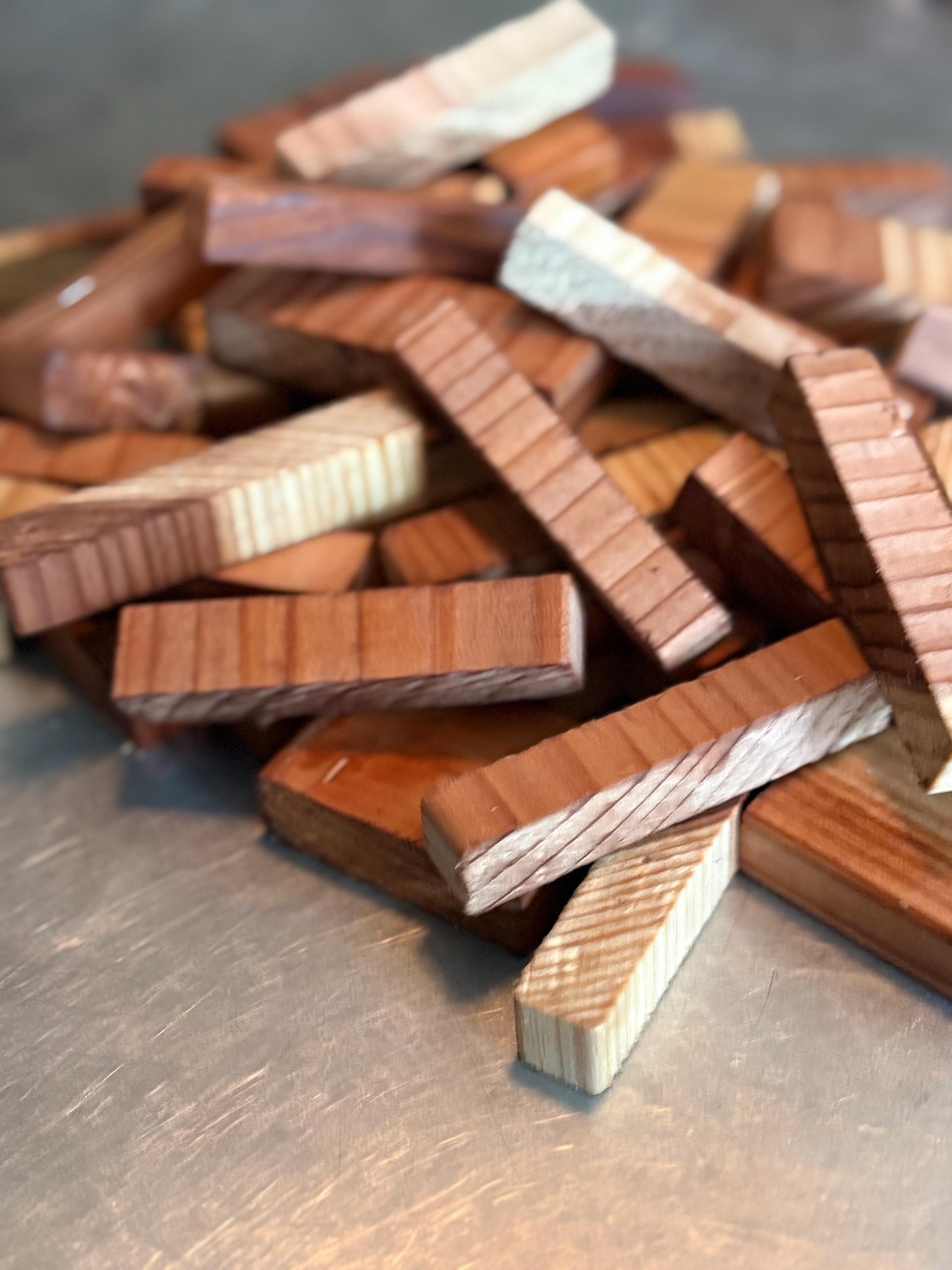 Small natural redwood blocks and offcuts with visible wood grain used for crafts, worm bins, and compost setups.